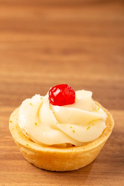 Lemon tartlets decorated with cherry