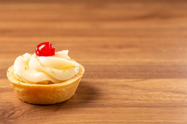 Lemon tartlets decorated with cherry