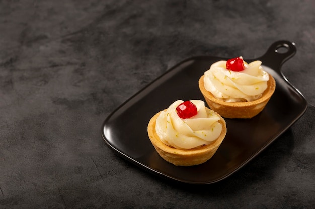 Lemon tartlets decorated with cherry