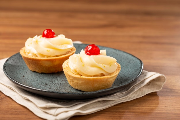 Lemon tartlets decorated with cherry