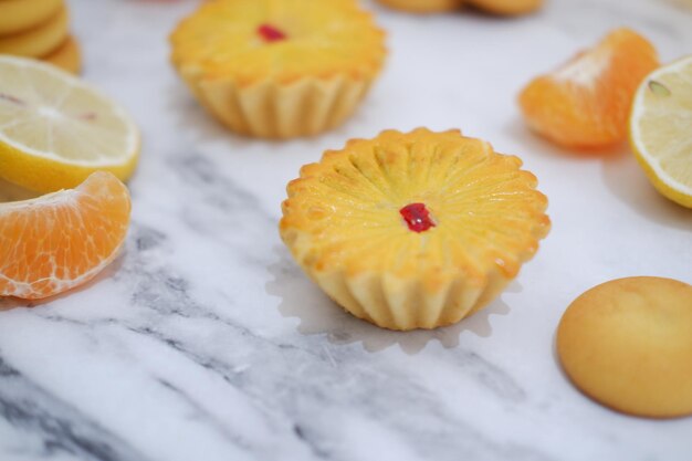 Lemon tartlets with fresh lemons and tangerines