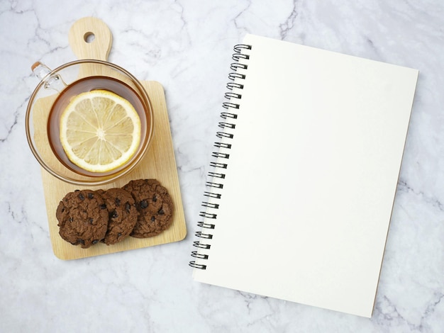 lemon tea and book on marble texture background