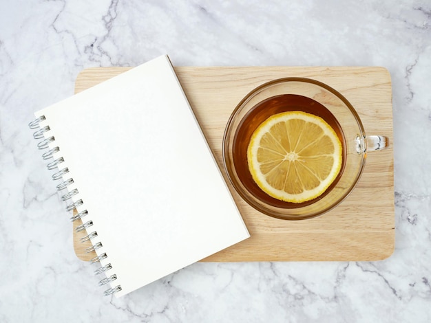 lemon tea and book on marble texture background