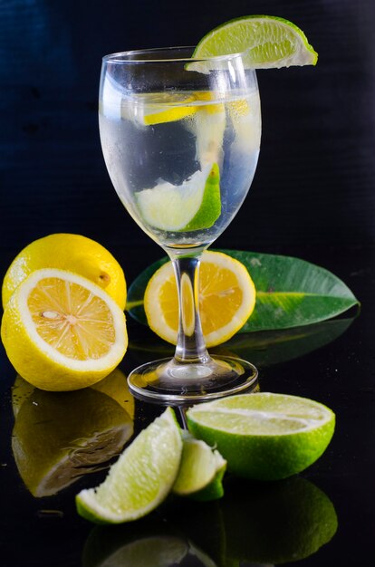 Lemon water and citrus on a black surface