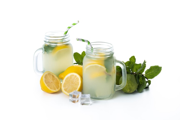 Lemonade drink in a jar glass and ingredients isolated on white background