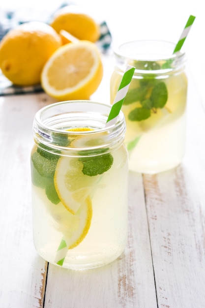 Lemonade drink in a jar glass on white wood