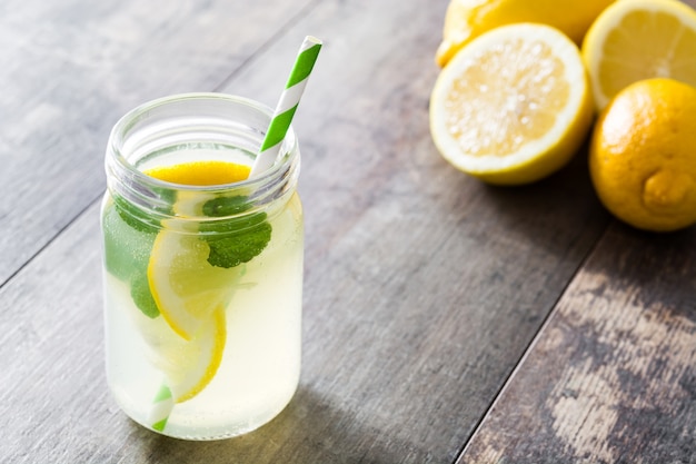 Lemonade drink in a jar glass on wood copy space