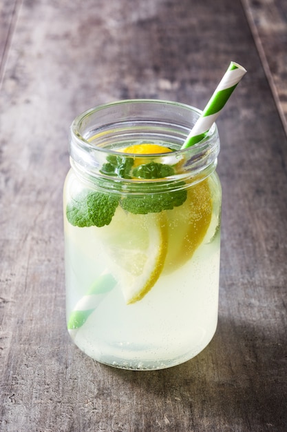 Lemonade drink in a jar glass on wood