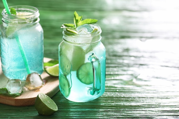 Lemonade from lime and mint in a glass jar on a table