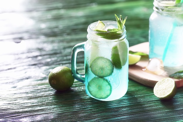 Lemonade from lime and mint in a glass jar on a table