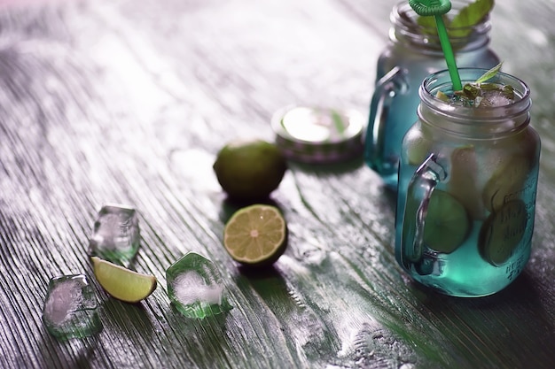 Lemonade from lime and mint in a glass jar on a table