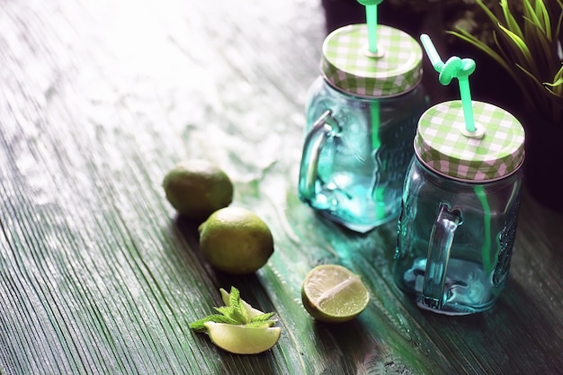 Lemonade from lime and mint in a glass jar on a table