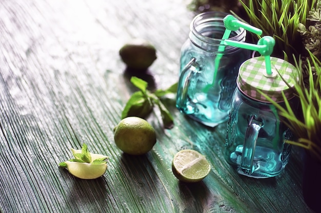 Lemonade from lime and mint in a glass jar on a table