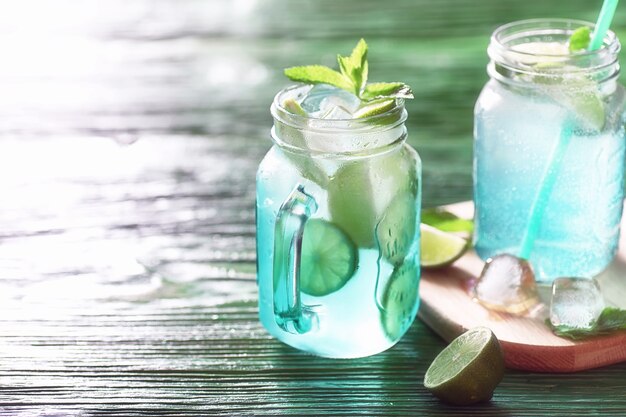 Lemonade from lime and mint in a glass jar on a table