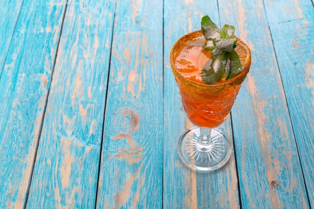 Lemonade in glass put on light blue wood table