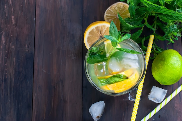 Lemonade in glass with ice and mint 