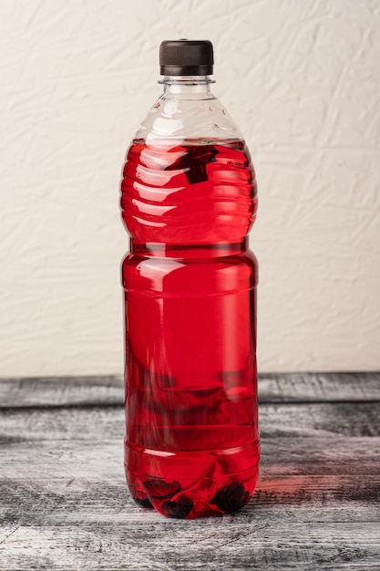 Lemonade homemade lemonade in a bottle on a white wooden background