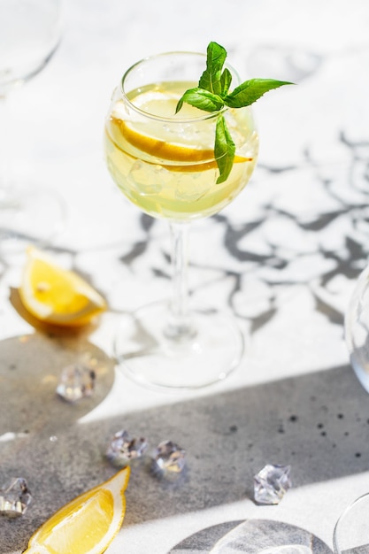 Lemonade or mojito cocktail with lemon and mint