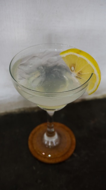 Lemonade refreshing sparkling drink in an elegant glass garnished with a lemon wedge