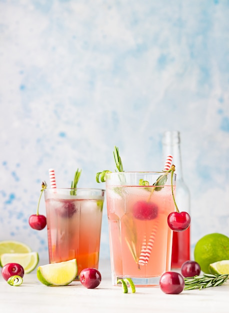 Lemonade with cherries, lime, and rosemary.