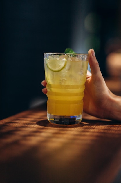 Lemonade with fresh lemon on background