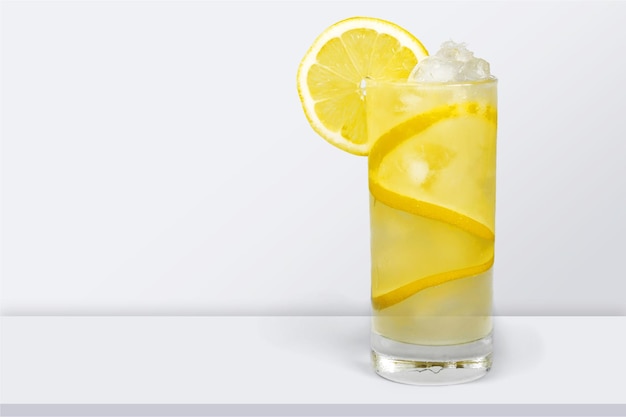 Lemonade with fresh lemon on desk