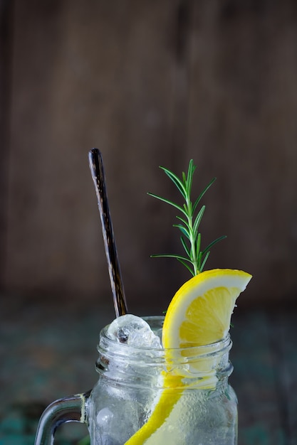 Lemonade with fresh lemon and rosemary in glass 