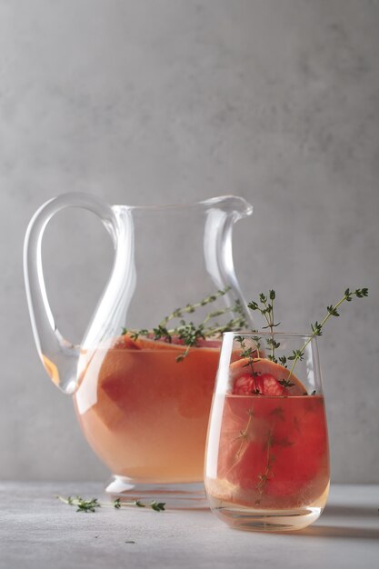 Lemonade with grapefruit. Refreshing decanter and glass of orange lemonade