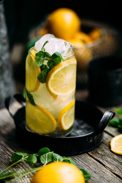 Lemonade with ice and mint on a white background