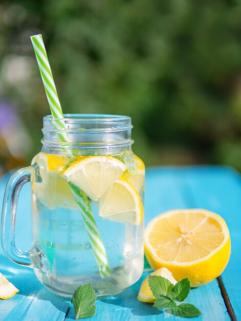 Lemonade with lemon and mint in a glass jar