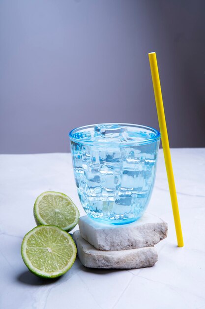 Lemonade with lemons in clear blue glass with ice