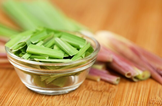 Lemongrass in a bowl on wooden surface