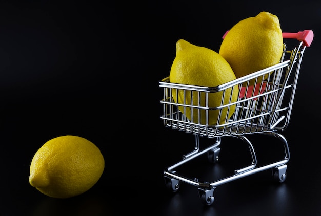 Lemons in a cart on black background