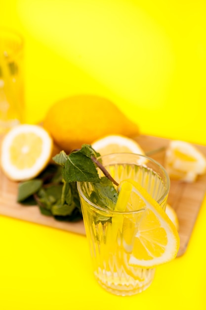 Photo lemons and detox water made of them on yellow background