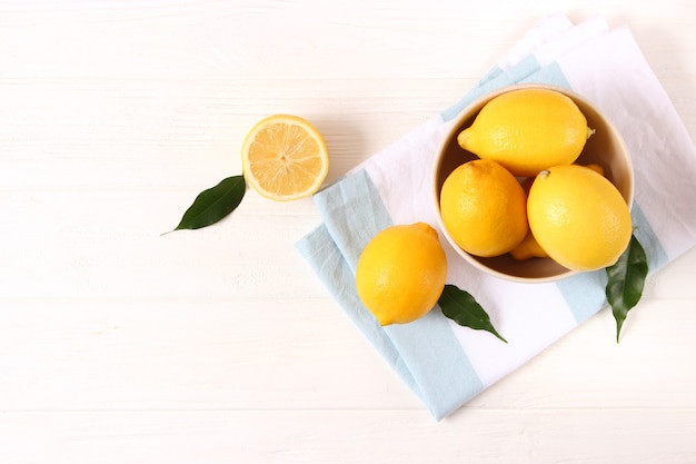 Lemons and green leaves on a colored background. High quality photo