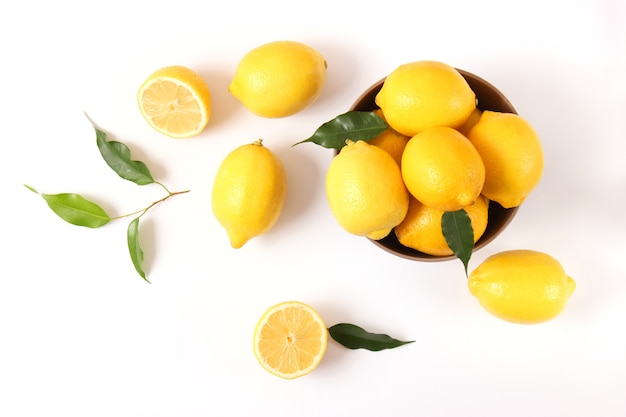 Lemons and green leaves on a colored background. High quality photo