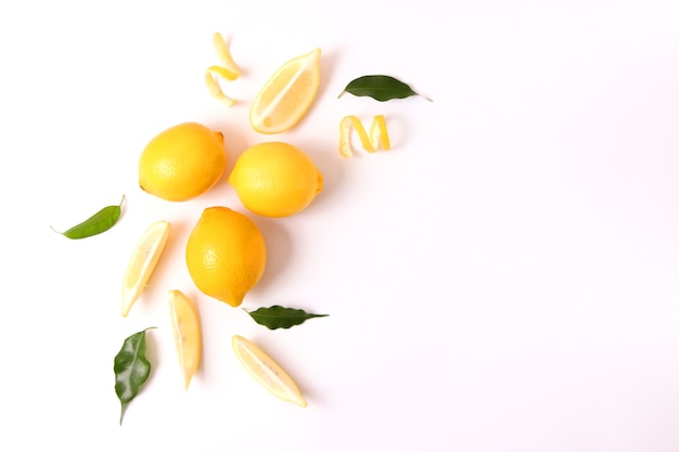 Lemons and green leaves on a colored background. High quality photo