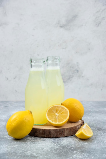 Lemons grey backround lemon juice and fresh on cutting board