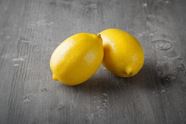 Lemons on grey wooden background