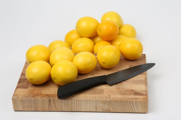 Lemons and knife are on cutting Board