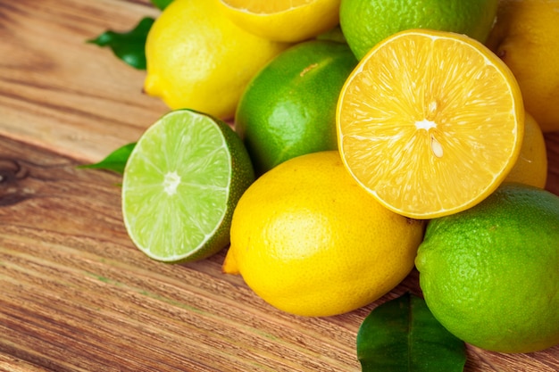 Lemons and limes on wooden pad