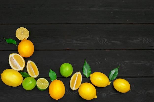 Lemons and limes on a wooden .