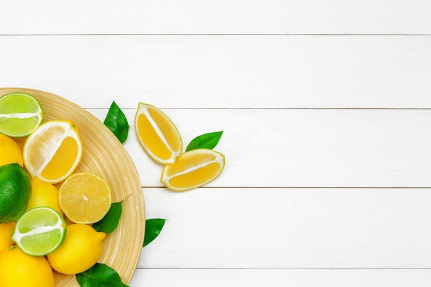 Lemons and limes on a wooden .