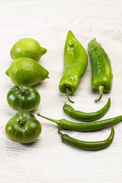 Lemons peppers and tomatoes on a white wooden table