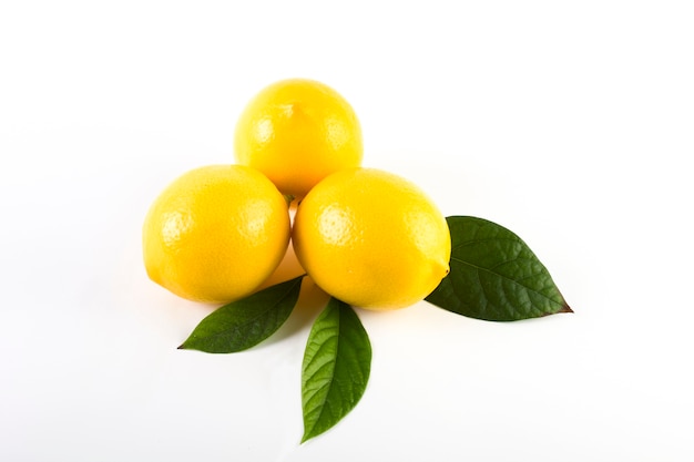 Lemons with leaves isolated close up