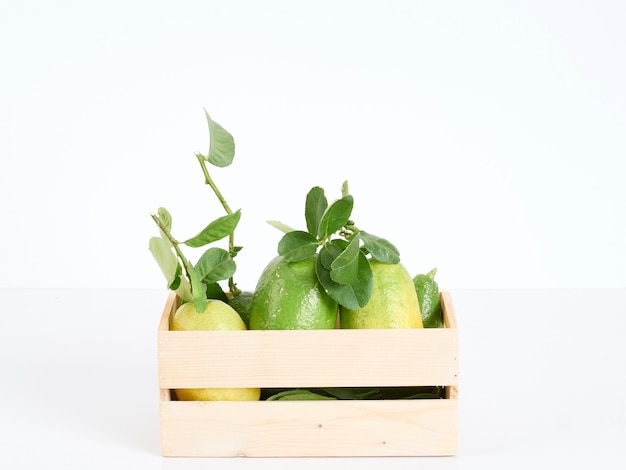 Lemons with leaves in wooden box