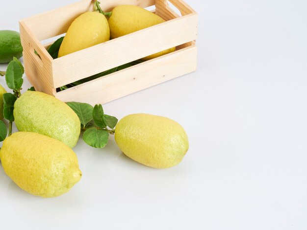 Lemons with leaves in wooden box