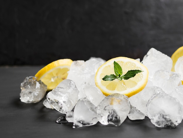 Lemons with mint and pile of ice cubes