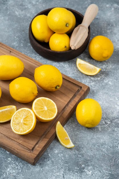 Lemons in wood bowl with cutting board