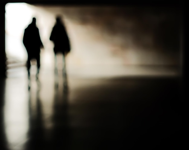 Photo lens blur image of two people in a tunnel